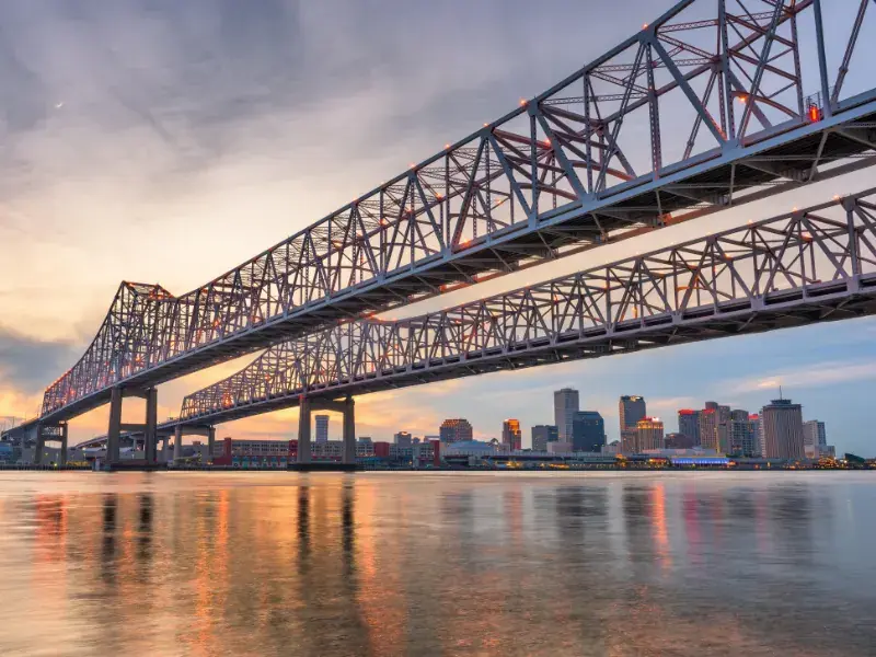 Crescent City Connection bridge over the Mississippi River with the New Orleans skyline at sunset